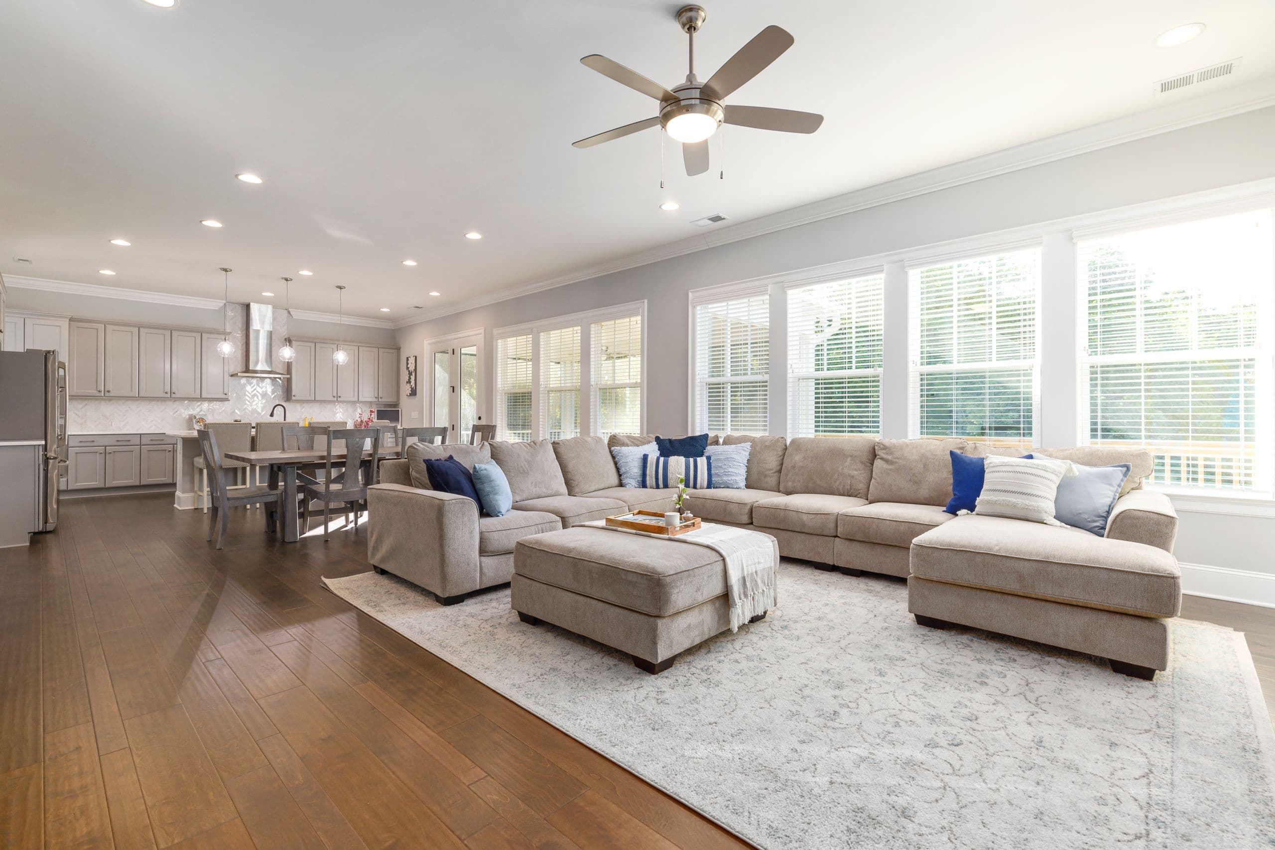 Great room with sectional and a wall of windows